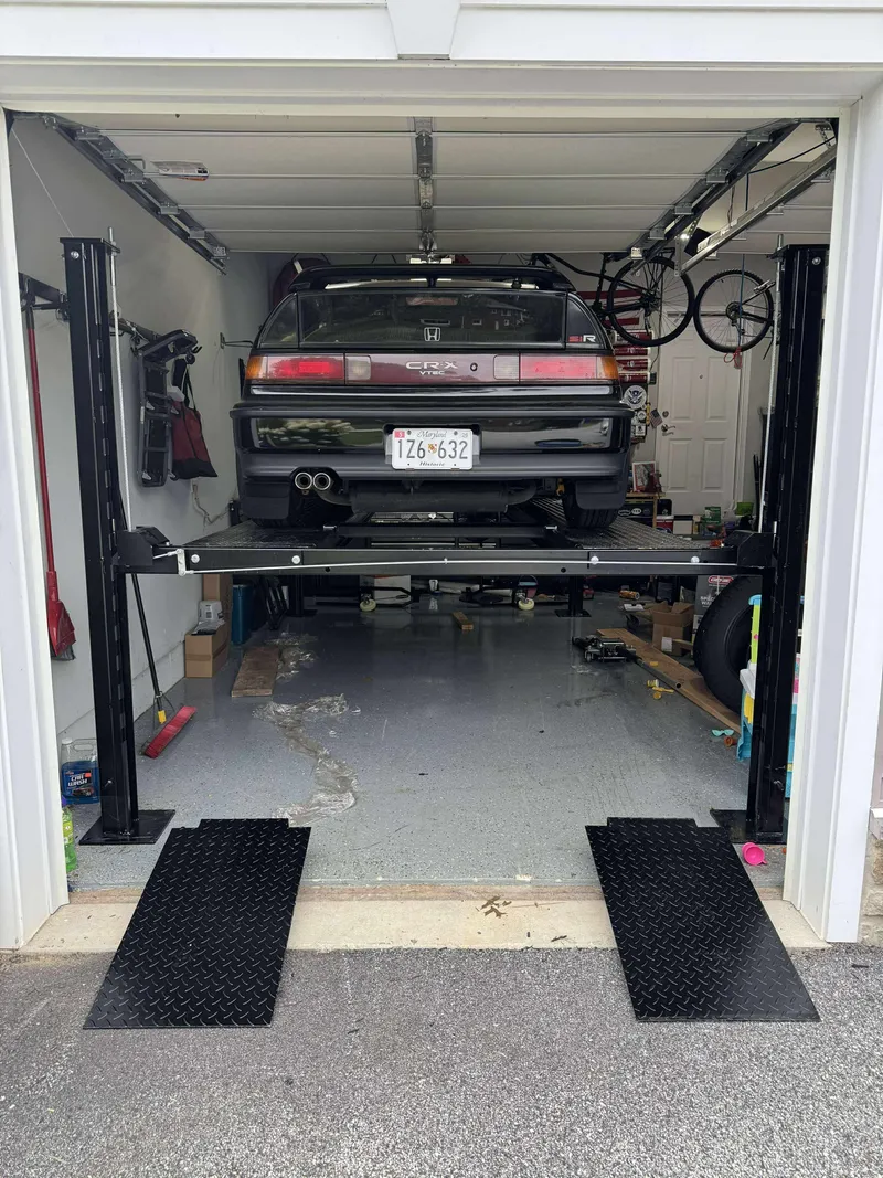 Four-post automotive lift installation