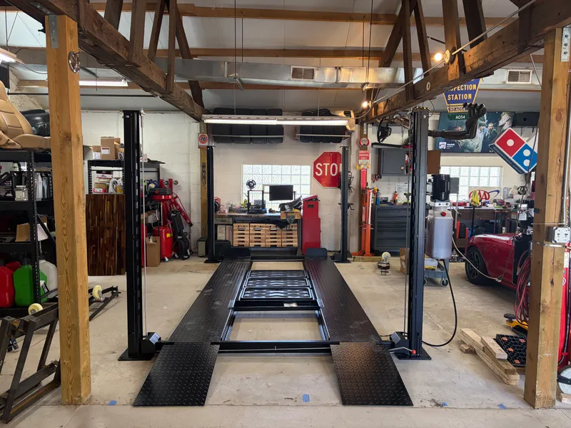Four-post automotive lift installation