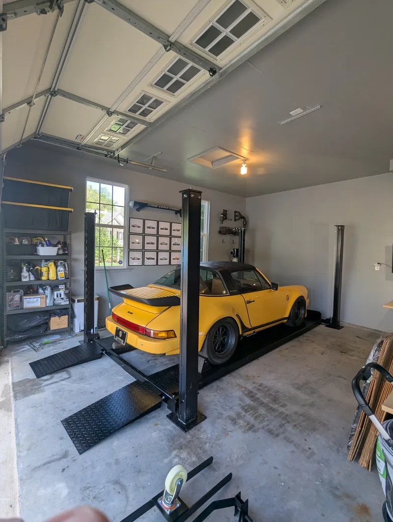 Four-post automotive lift installation